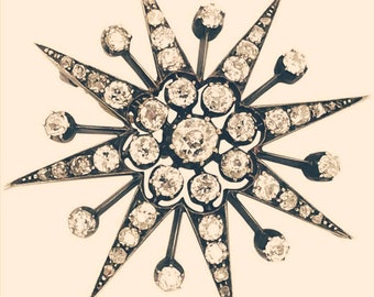 May include: A silver and diamond starburst brooch with a central cluster of diamonds and smaller diamonds set along the points of the star.