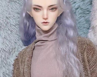 May include: A doll with long, wavy, light purple hair wearing a brown cardigan over a light pink turtleneck sweater.