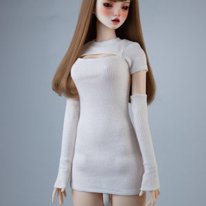 May include: A white ribbed knit dress with a cutout detail at the neckline and matching long sleeves. The dress is fitted and has a short length.