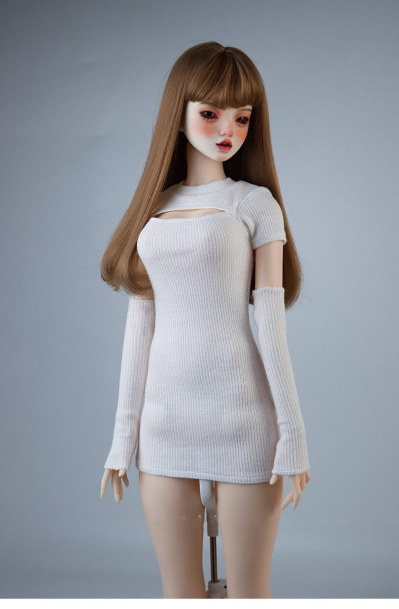 May include: A white ribbed knit dress with a cutout detail at the neckline and matching long sleeves. The dress is fitted and has a short length.