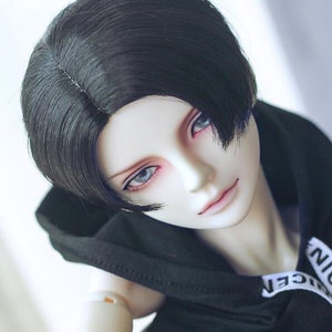 May include: A black wig with a side part and bangs. The wig is styled in a short, layered cut.