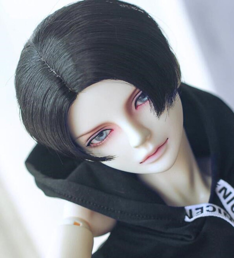 May include: A black wig with a side part and bangs. The wig is styled in a short, layered cut.