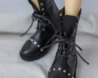 May include: Black leather ankle boots with silver studs and laces. The boots have a rounded toe and a chunky heel.
