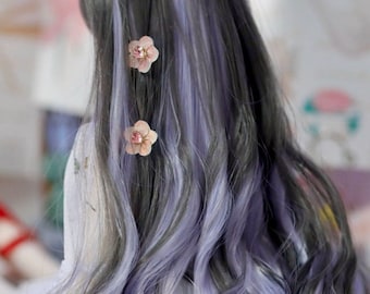 May include: Long, wavy black and purple hair with two pink flower hair clips.