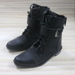 May include: A pair of black leather ankle boots with buckles and laces. The boots have a rounded toe and a low heel.