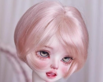 May include: A doll with a short, light pink wig. The doll has blue eyes and a light pink complexion.