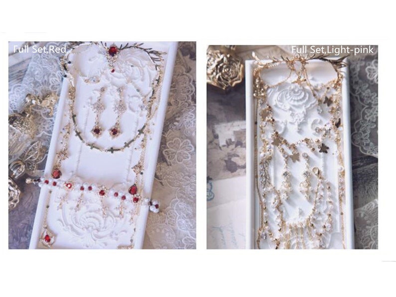 May include: Two jewelry sets displayed on white rectangular trays. The left set, labeled Full Set, Red, features gold-tone chains, red teardrop stones, and cross charms. The right set, labeled Full Set, Light-pink, includes gold-tone chains, butterfly charms, and light pink accents.
