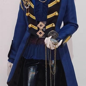 May include: A blue and black military-style jacket with gold trim and buttons. The jacket has a high collar and a long, flowing tail. The jacket is decorated with gold chains and a large, ornate brooch.