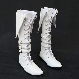 May include: A pair of white knee-high boots with lace-up fronts and buckle straps. The boots have pointed toes and a slightly flared top.