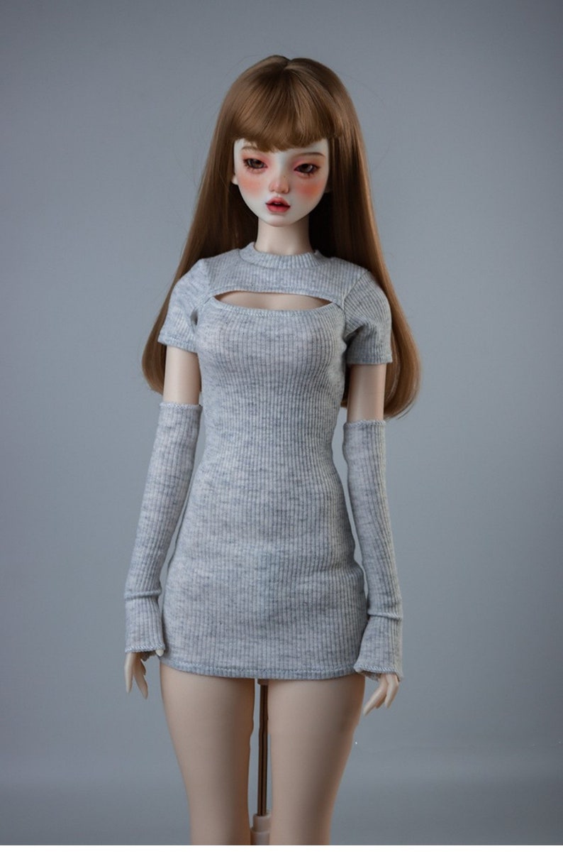 May include: A grey ribbed knit dress with a cutout neckline and matching long sleeves. The dress is fitted and has a short length.