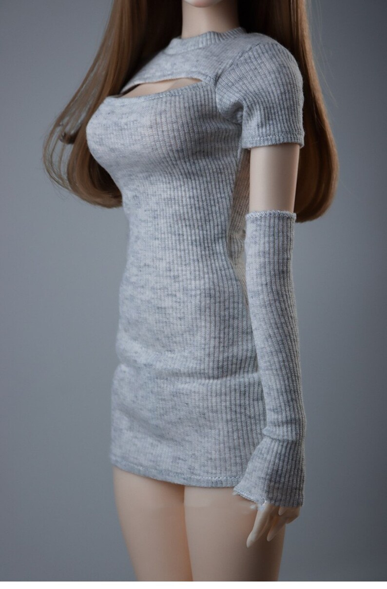 May include: A grey ribbed knit dress with a cutout at the neckline and matching ribbed knit arm warmers.