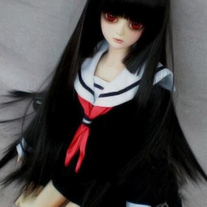 May include: A black haired doll with red eyes wearing a black and white sailor uniform with a red bow tie.