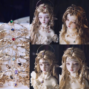 May include: A collection of gold-toned metal headpieces featuring intricate leaf and branch designs, accented with colorful faceted gemstones, clear crystals, and delicate hanging chains, displayed alongside a doll wearing similar jewelry.