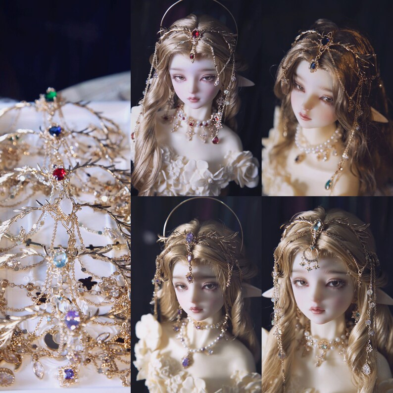 May include: A collection of gold-toned metal headpieces featuring intricate leaf and branch designs, accented with colorful faceted gemstones, clear crystals, and delicate hanging chains, displayed alongside a doll wearing similar jewelry.