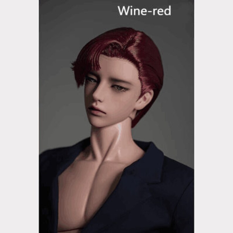May include: A doll with a wine-red wig and a dark blue blazer. The doll has a neutral expression and is looking to the side.