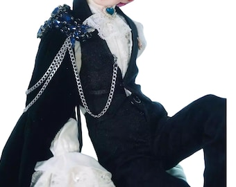 May include: A black suit with a white ruffled shirt and a black cape adorned with blue jewels and silver chains. The outfit includes a black vest and pants, creating a gothic or Victorian aesthetic.