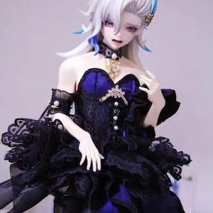 May include: A detailed figurine of a woman with white hair, wearing a black and blue dress with lace detailing. She has a jeweled crown and choker. The dress has a layered skirt and is adorned with pearls.