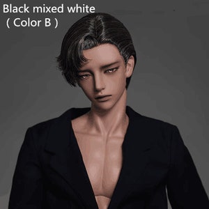 May include: A doll with black mixed white hair wearing a black blazer. The doll has a neutral expression and is looking down.