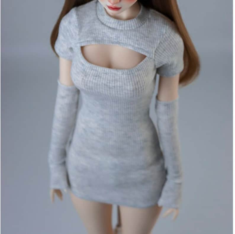 May include: A grey ribbed knit dress with a cutout at the chest and matching long sleeves. The dress is fitted and has a short length.