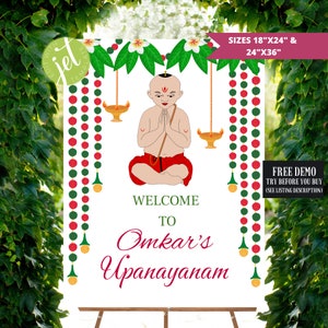 May include: Welcome to Omkar's Upanayanam sign with a cartoon illustration of a boy in a red and white outfit, sitting in a meditative pose with his hands clasped together. The sign is decorated with green and red garlands and gold diyas.