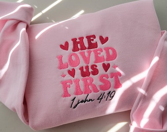 Embroidered He Loved Us First Sweatshirt, Pink Crewneck, Bible Verse, Christian Gift Sweatshirt, Jesus Valentines Embroidered Sweater