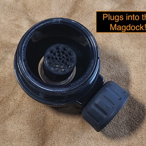 May include: Black plastic coffee filter with a mesh insert. The filter has a threaded bottom that plugs into the Magdock!.