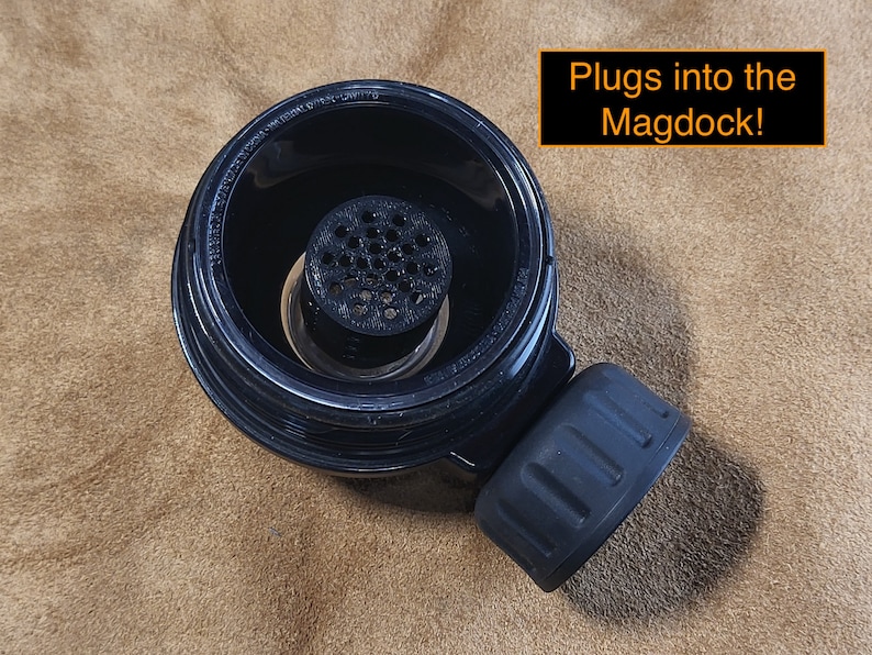 May include: Black plastic coffee filter with a mesh insert. The filter has a threaded bottom that plugs into the Magdock!.