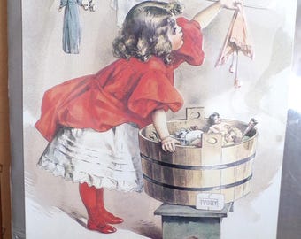 Letrero metálico decorativo magnético vintage "Laundry Peddler" de Ivory Soap con una niña lavando la ropa, estilo retro, 17 x 12 pulgadas, nuevo sin usar.