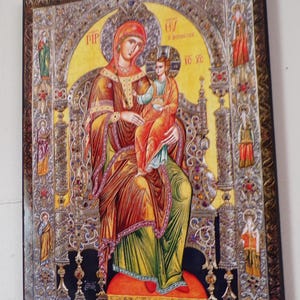 May include: A white ceramic mug with a black handle and the text "But First, Coffee" in a black, handwritten-style font. The mug is on a white surface.