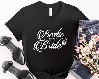 May include: Black t-shirt with white text that says "Bestie of the Bride" with a diamond graphic.