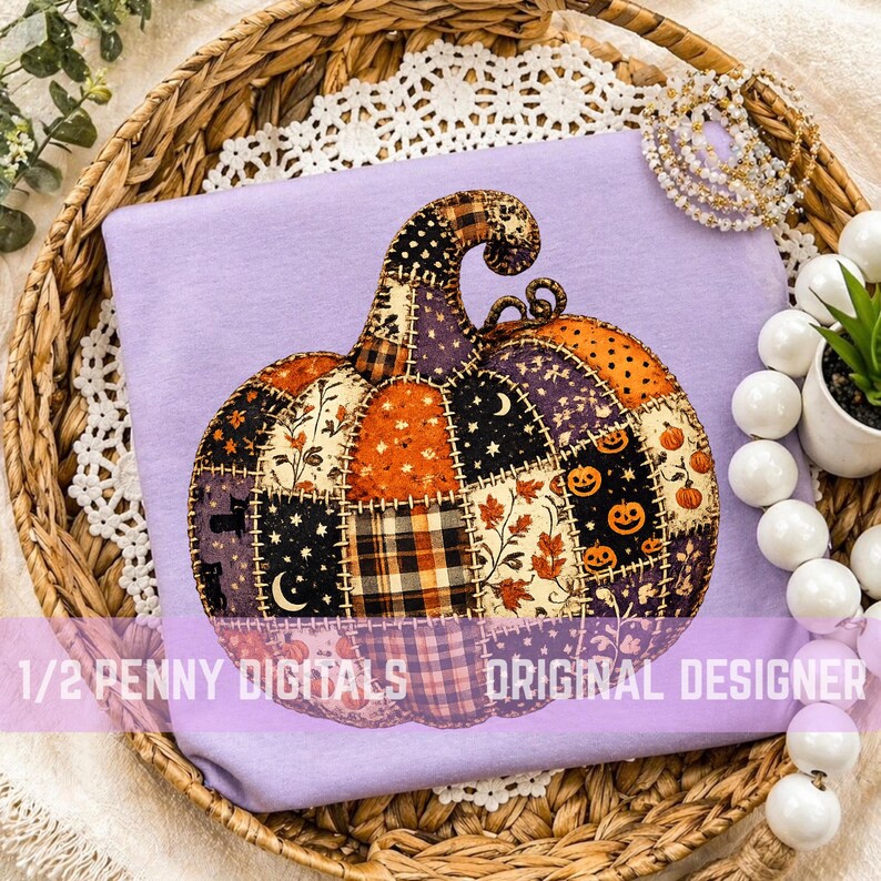 May include: A light purple t-shirt featuring a large, central graphic of a pumpkin constructed from various patchwork fabric patterns, including plaid, stars, moons, leaves, and jack-o'-lanterns, with the text 1/2 PENNY DIGITALS ORIGINAL DESIGNER.