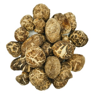 May include: A pile of dried shiitake mushrooms, a popular ingredient in Asian cuisine. The mushrooms are brown and have a slightly wrinkled texture.