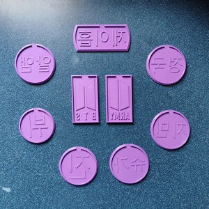 May include: Nine purple coasters with Korean text and the letters "BTS" and "YUMJA".