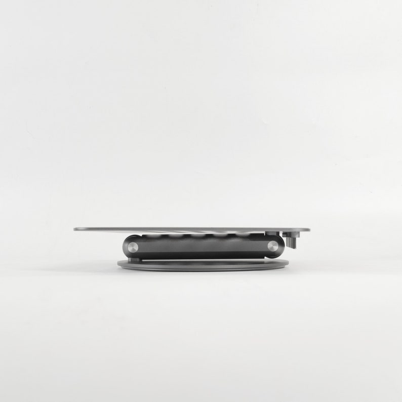A folded laptop stand is displayed on the side against a white background.