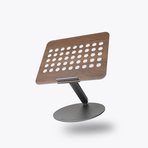 A laptop stand floats against a white background.