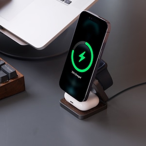 A 3 in 1 charger that charges iPhones, AirPods, and Apple Watches sits next to the computer.