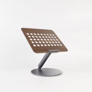 A laptop stand is displayed on the side against a white background.