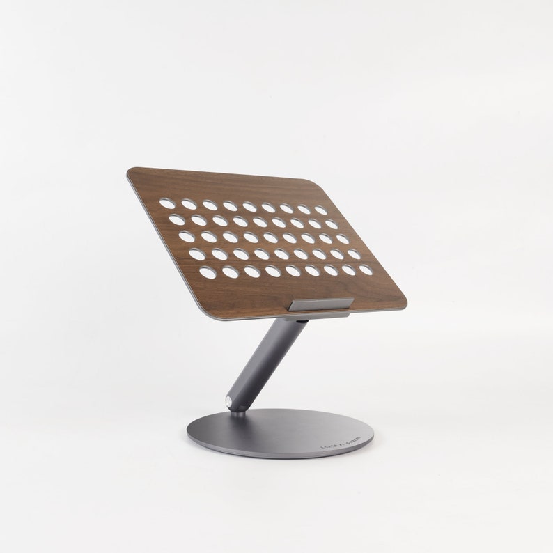 A laptop stand is displayed on the side against a white background.