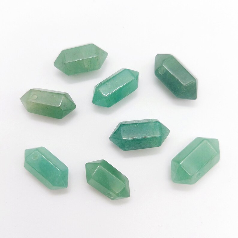May include: Eight green gemstone beads in the shape of a pointed oval. The beads have a smooth, polished finish and are ideal for jewelry making.