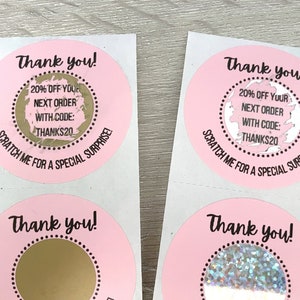 May include: Four pink and white round stickers with the text "Thank you!" and "20% off your next order with code: THANKS20" and "Scratch me for a special surprise!" Each sticker has a gold or silver circle in the center that can be scratched off to reveal a surprise.