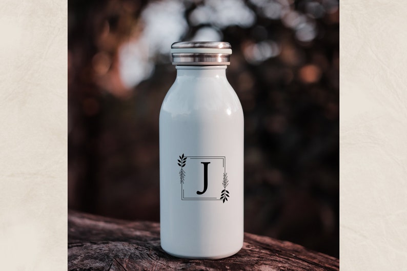 May include: White stainless steel water bottle with a black and white floral design and the letter "J" in a square frame.