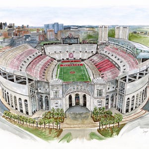 May include: A watercolor painting of Ohio Stadium, also known as The Horseshoe, in Columbus, Ohio. The stadium is shown from an aerial view, with the field and seating visible. The stadium is surrounded by trees and buildings.