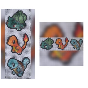 May include: Cross-stitch bookmark featuring four Pokemon characters: Bulbasaur, Charmander, Squirtle, and a fourth Pokemon. The bookmark is white with black outlines and colorful details.