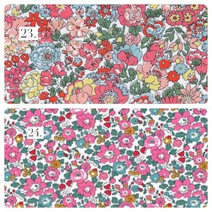May include: Two fabric swatches featuring floral patterns. Swatch 23 displays a dense arrangement of pink, red, yellow, and light blue flowers with green leaves on a white background. Swatch 24 shows smaller pink and blue flowers with green foliage.