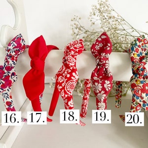 May include: Five red headbands with different floral patterns. The headbands are numbered 16 through 20.
