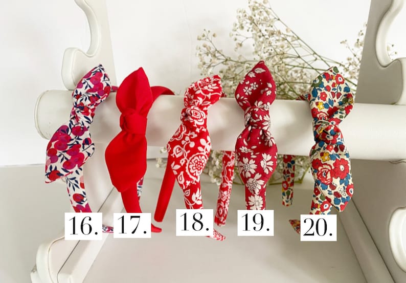 May include: Five red headbands with different floral patterns. The headbands are numbered 16 through 20.