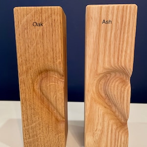 Image shows identical vertical tea light holders with 3D heart (half) for comparison of oak to ash woods.