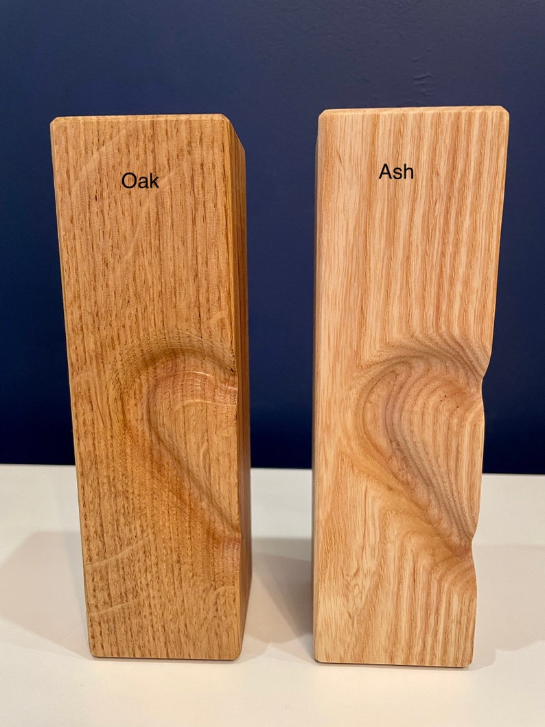 Image shows identical vertical tea light holders with 3D heart (half) for comparison of oak to ash woods.