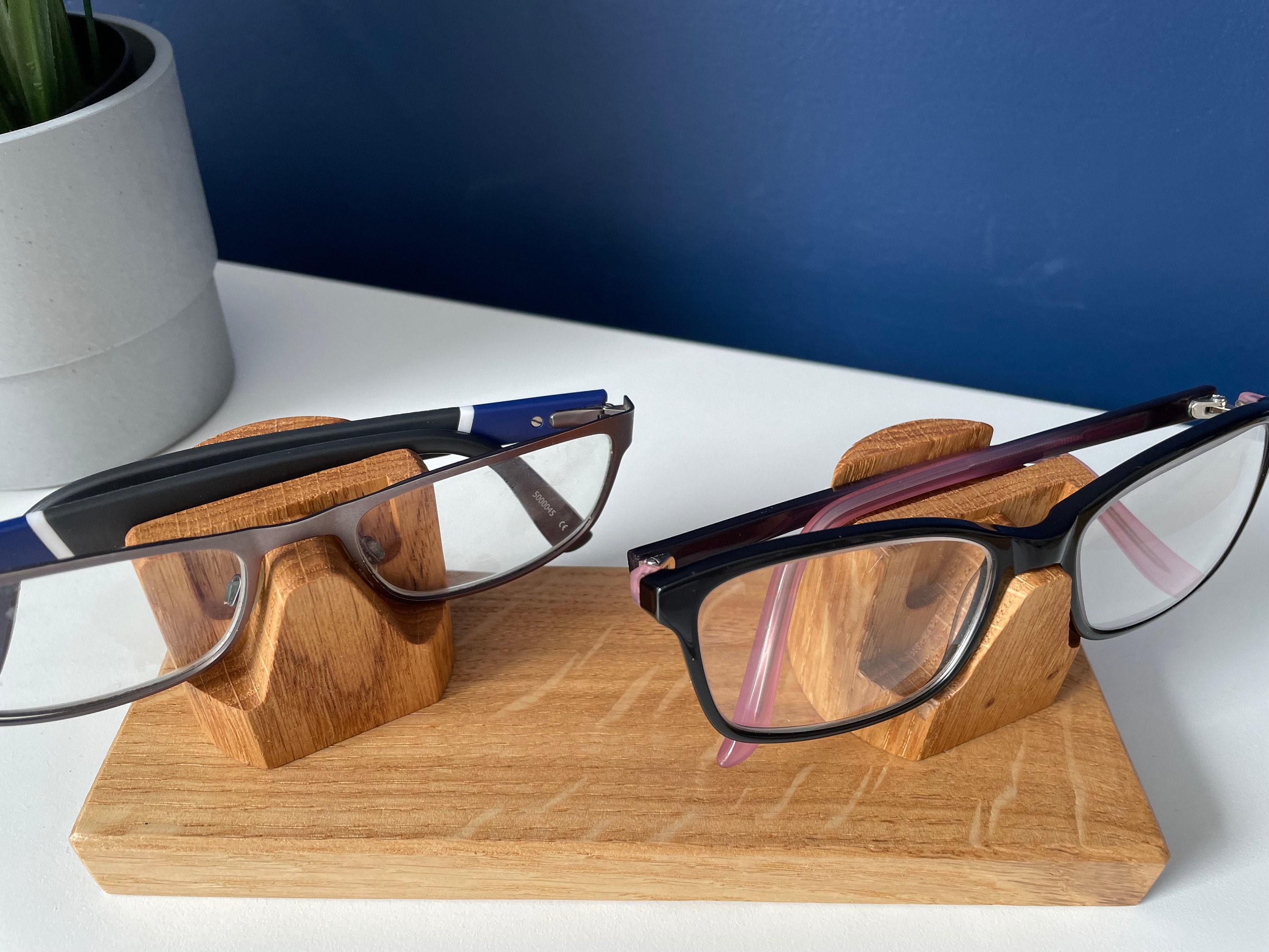 8 benefits of a spectacle holder  Wooden glasses holder, Eyewear store  design, Eyewear display