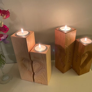 Two tall vertical rectangular square section pillar style candle holders. 3D engraved heart over the two pieces.  Recess on top of towers to sit tea light cups in. Engraved personalisation appears on the two inner faces to conceal the chosen wording.